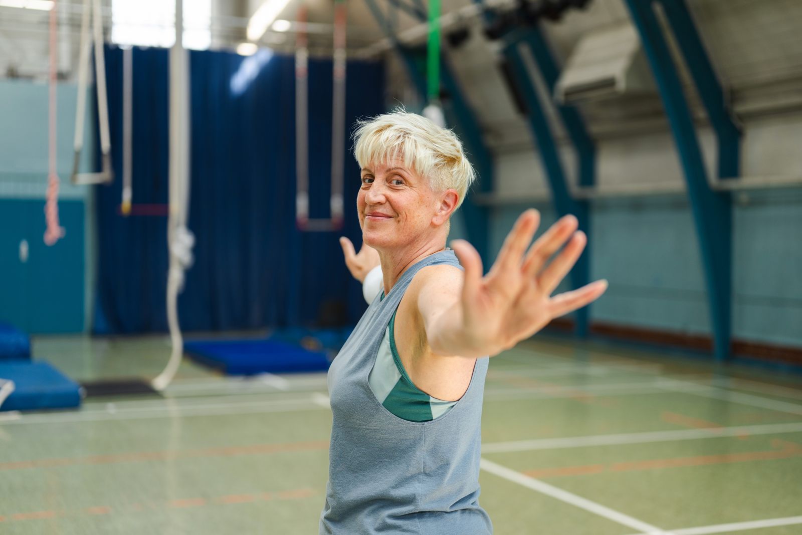Older adult stretching in an indoor exercise setting